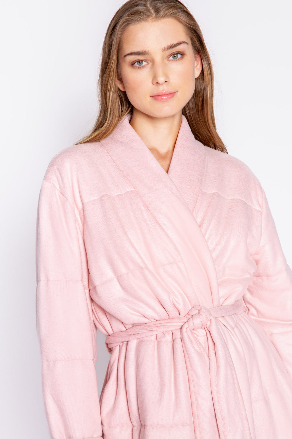 Pale pink wrap robe in horizontal quilted peachy fabric. Robe has self belt, knee length. (7068592570468)