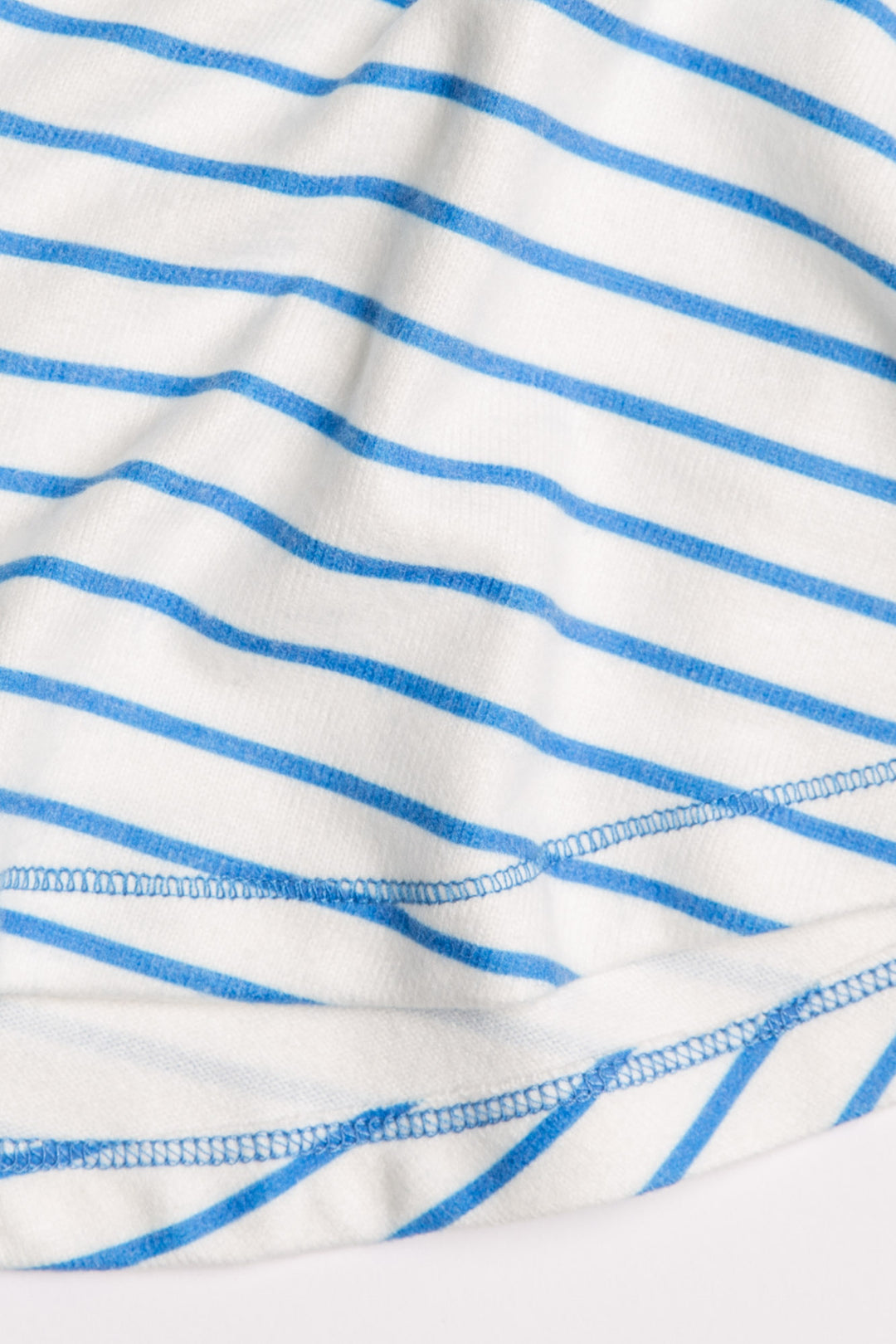 Ivory racerback tank top with blue striped print on peachy jersey fabric. (7125182873700)