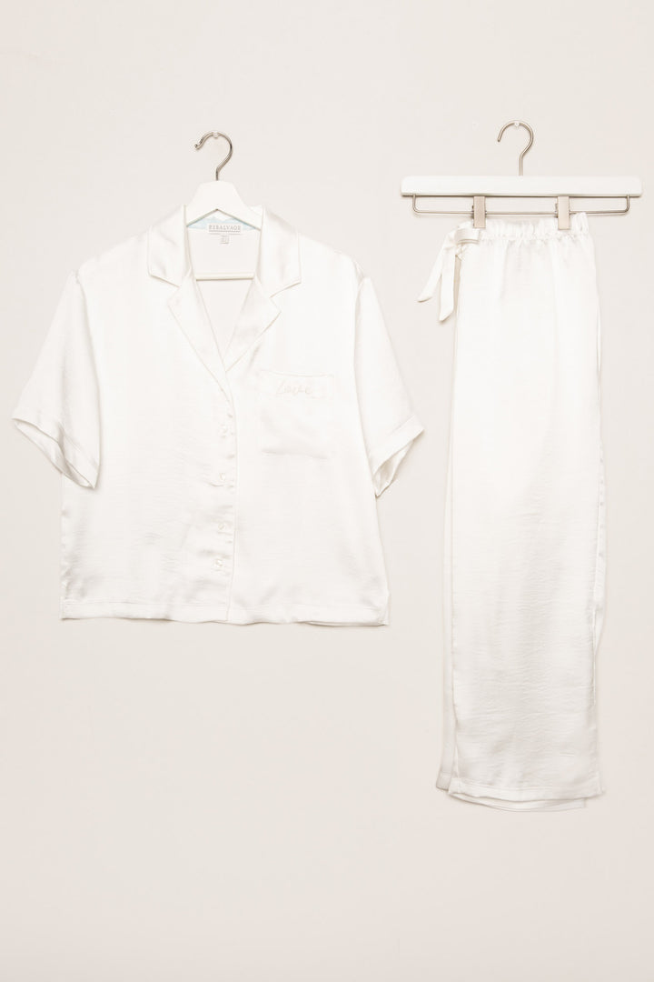 White lounge set in aloe-infused woven faux silk with short sleeve button-down top and lounge pant. (7125190934628)
