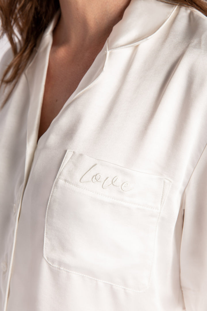 White lounge set in aloe-infused woven faux silk with short sleeve button-down top and lounge pant. (7125190934628)