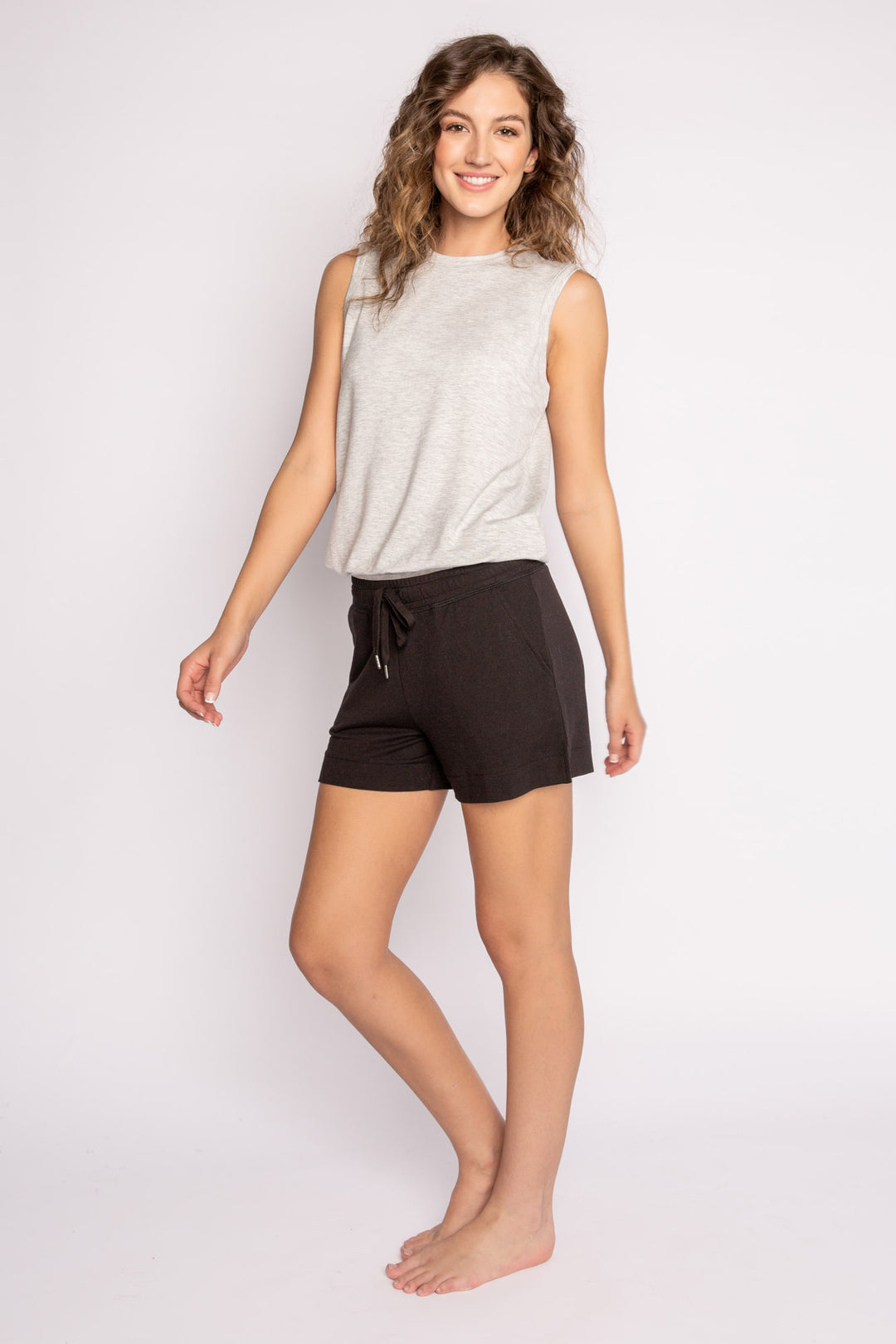 Black mini terry lounge shorts with side slit, tie waistband & pockets. (7122608521316)