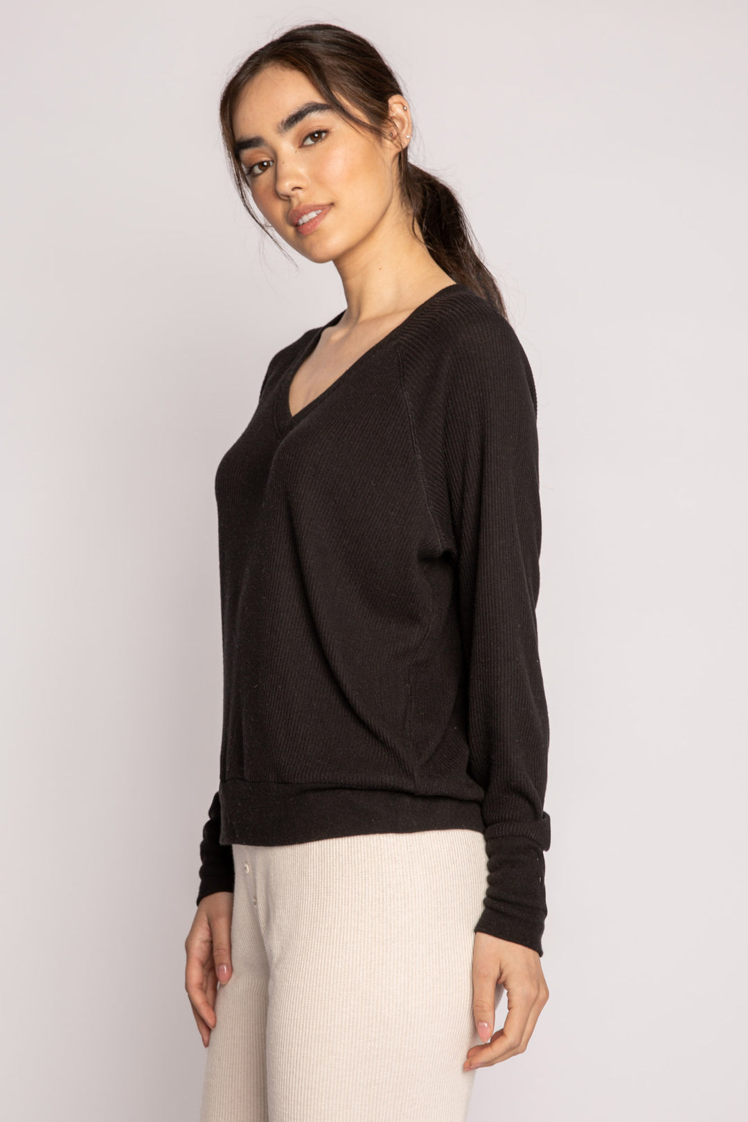 Black V-neck top with relaxed fit in 2x2 peachy rib. Banded sleeve cuff & neck rib. (7122611535972)