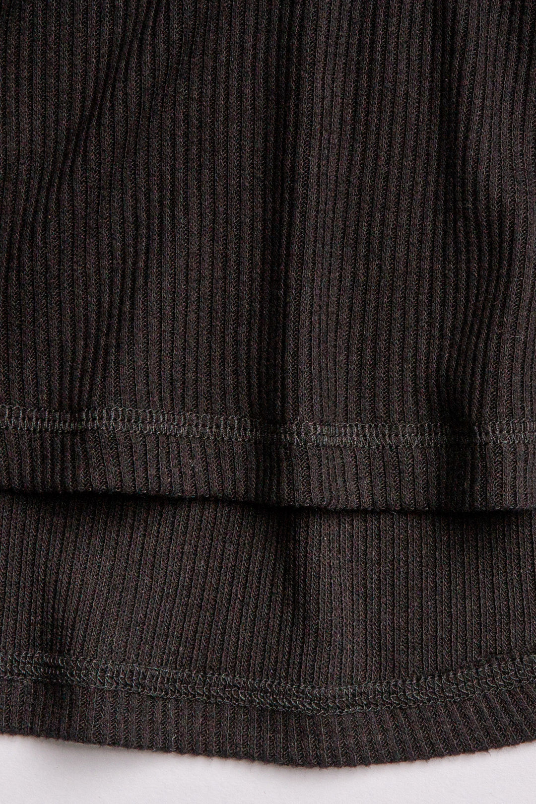 Black V-neck top with relaxed fit in 2x2 peachy rib. Banded sleeve cuff & neck rib. (7122611535972)