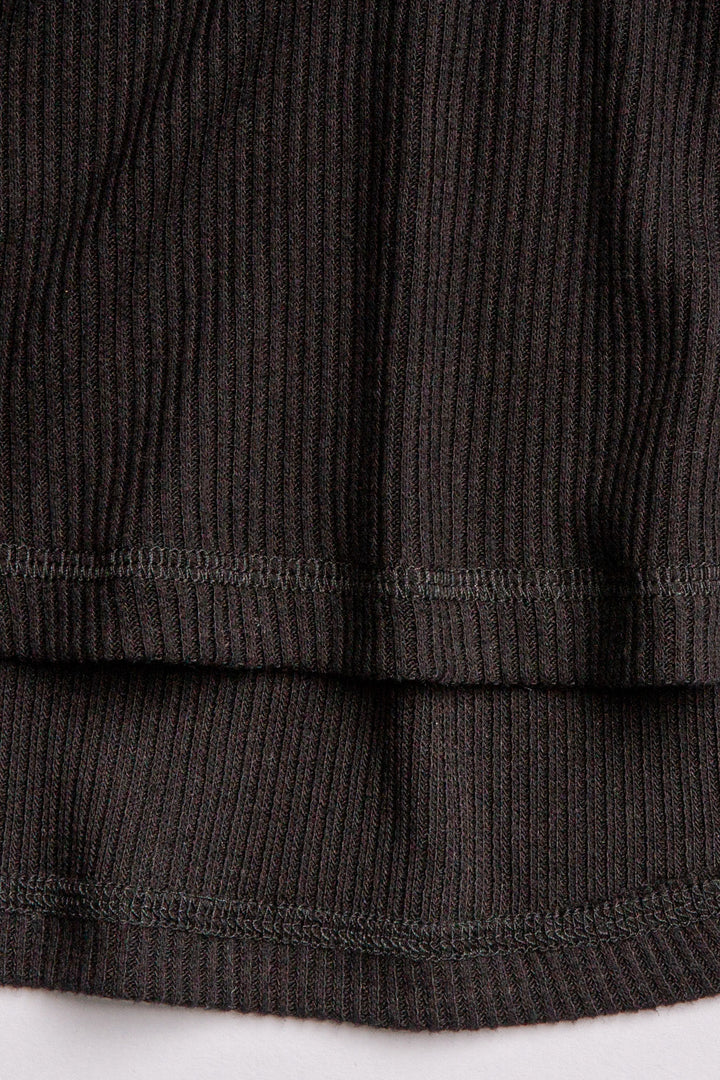 Black V-neck top with relaxed fit in 2x2 peachy rib. Banded sleeve cuff & neck rib. (7122611535972)