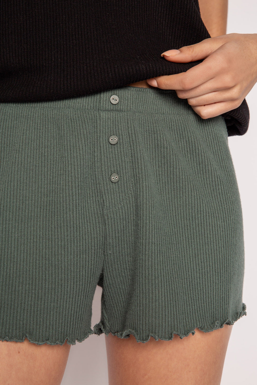 Green sleep short in 2x2 rib peachy jersey. With merrowed edge hem, and tiny faux buttons at fly. (7122612453476)