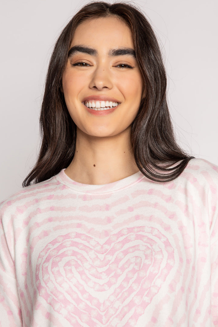 Ivory t-shirt in peachy knit with heart-patterned tie-dye in pink. Boxy, relaxed fit, open hem. (7215133818980)