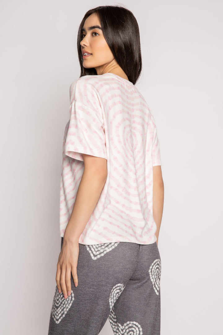 Ivory t-shirt in peachy knit with heart-patterned tie-dye in pink. Boxy, relaxed fit, open hem. (7215133818980)