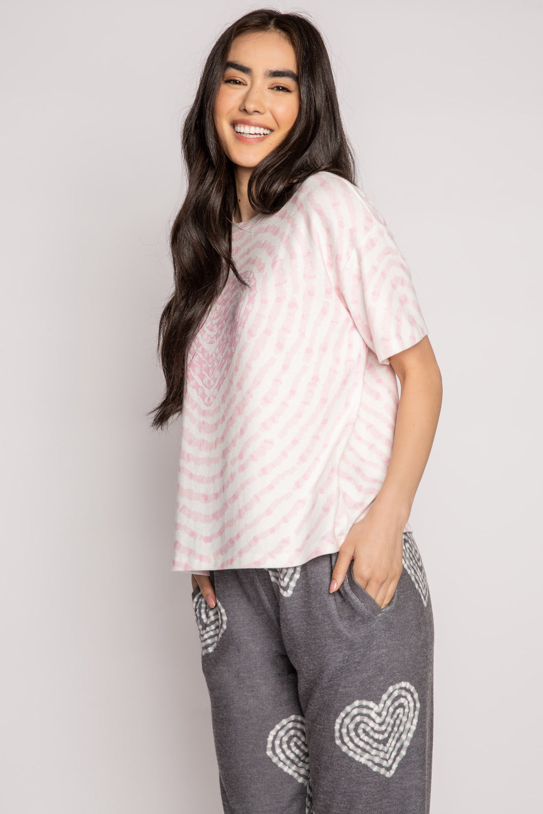 Ivory t-shirt in peachy knit with heart-patterned tie-dye in pink. Boxy, relaxed fit, open hem. (7215133818980)