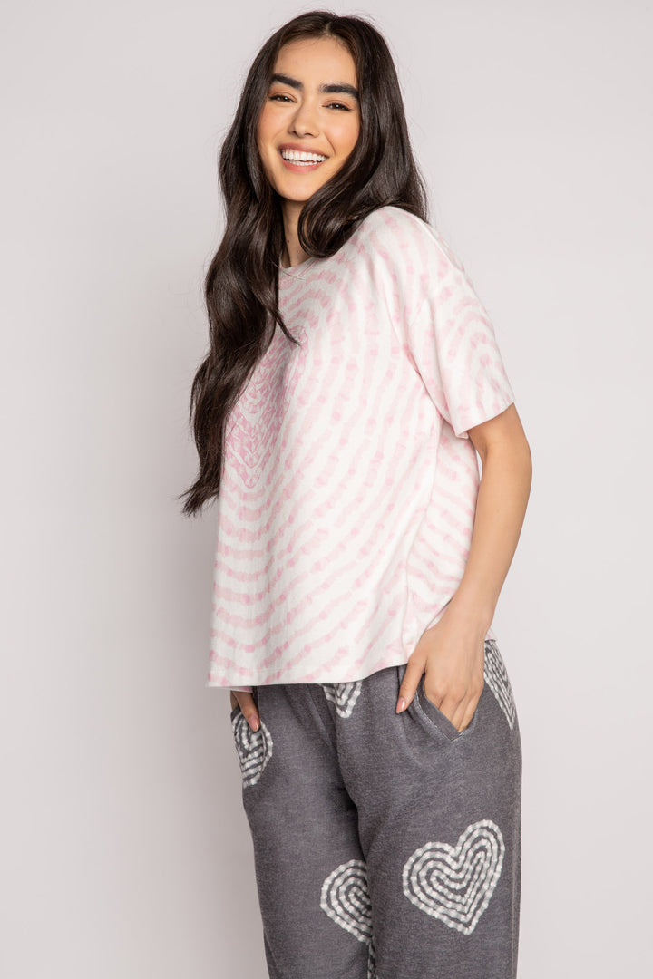 Ivory t-shirt in peachy knit with heart-patterned tie-dye in pink. Boxy, relaxed fit, open hem. (7215133818980)