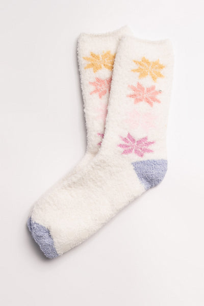Ivory cozy plush socks with pastel knitted snowflake design. Clear-printed grippers on soles. (7231871516772)