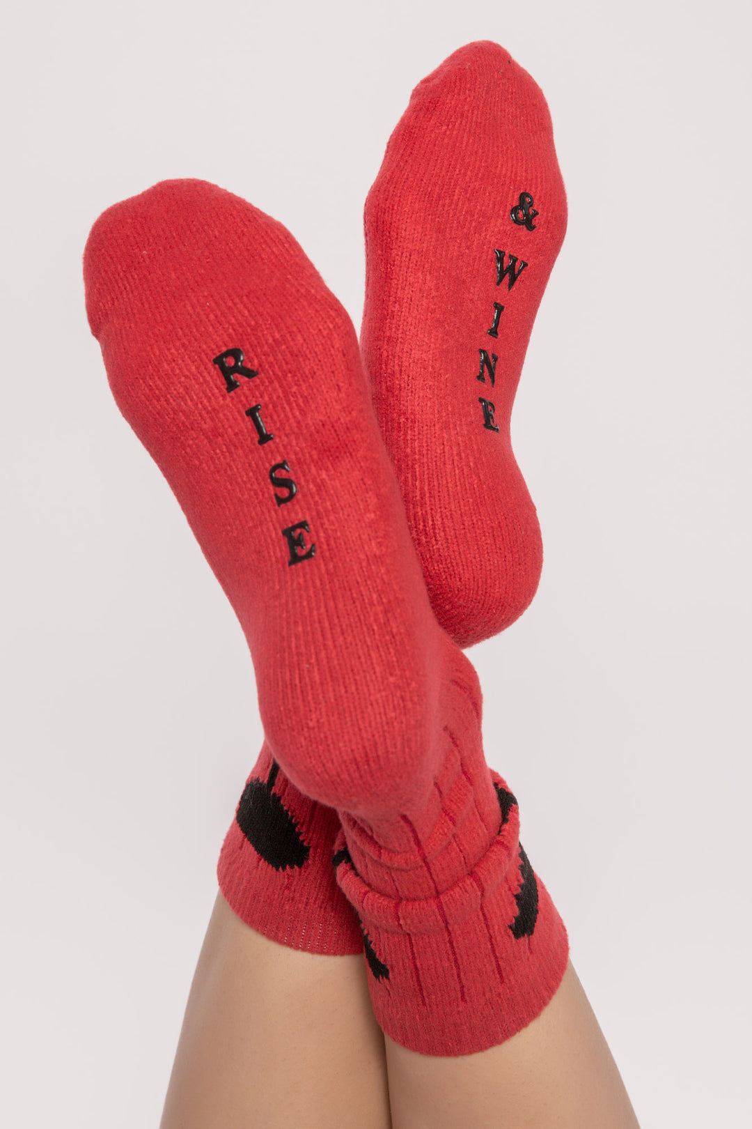 Red ribbed socks with wine glasses on ankle & 'rise & wine " printed gripper graphic on soles. (7231871778916)
