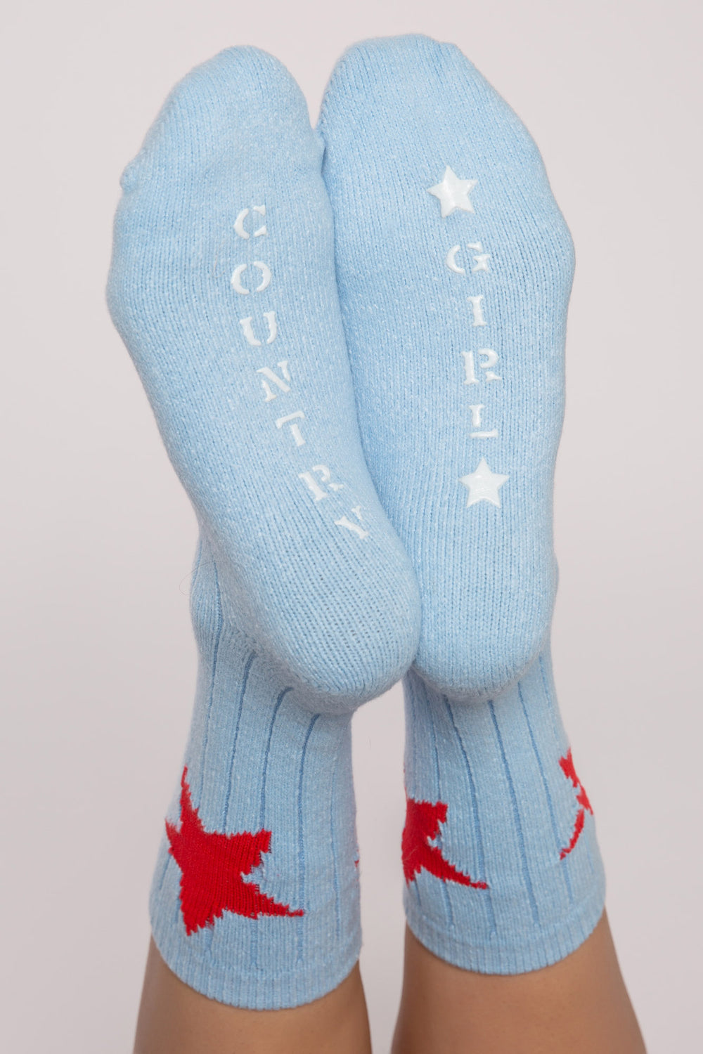 Soft blue ribbed socks with red stars on ankle & 'Country Girl' printed gripper graphic on soles. (7231871713380)