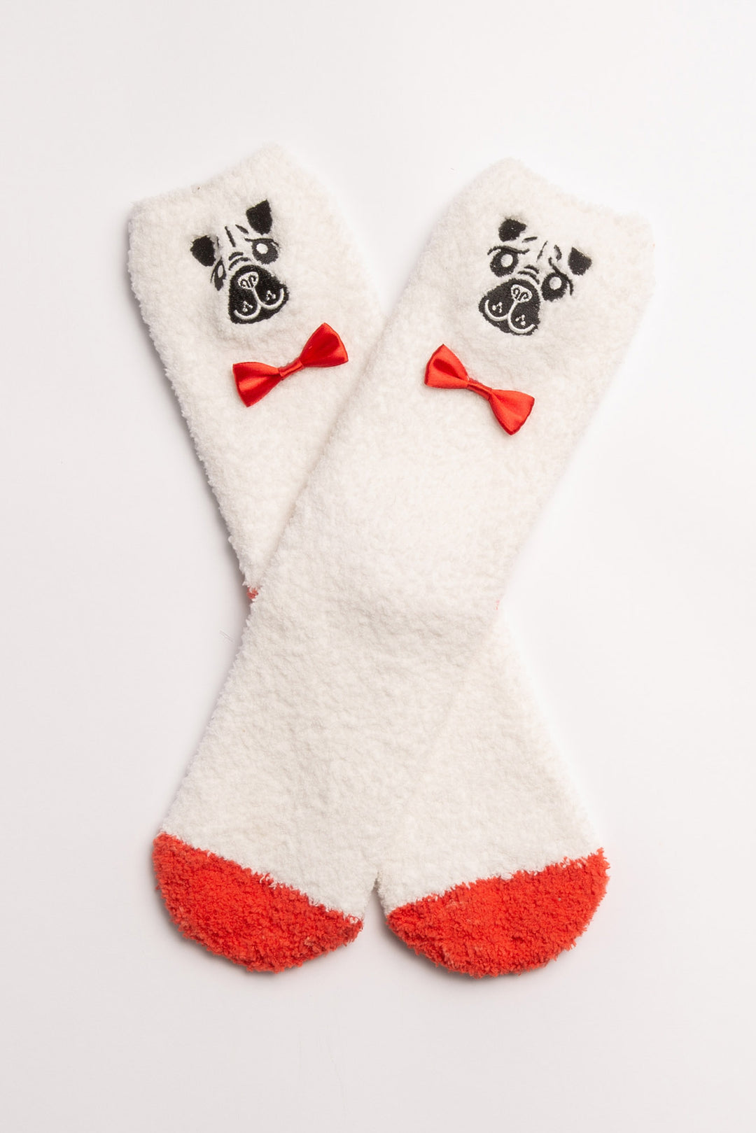 Ivory cozy plush socks with knitted dog face & bowtie. Clear-printed grippers on soles. (7231871942756)