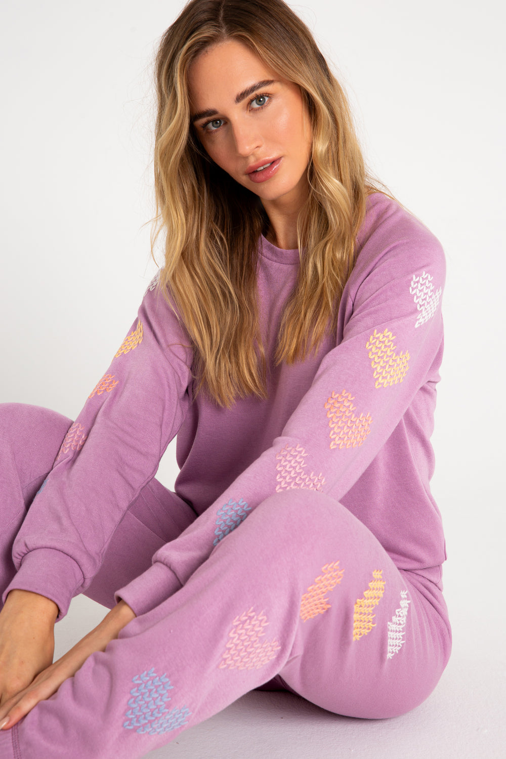 Fleece pullover top in mauve with multi-color heart printed on sleeves. (7231877677156)