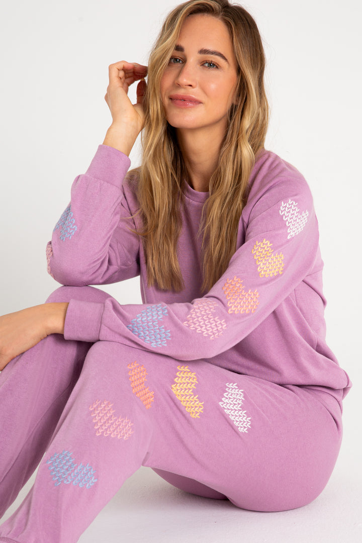 Fleece jogger in mauve with multi-color heart printed on sides. (7231878266980)