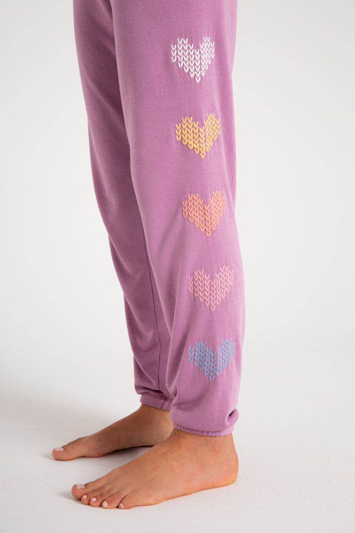 Fleece jogger in mauve with multi-color heart printed on sides. (7231878266980)