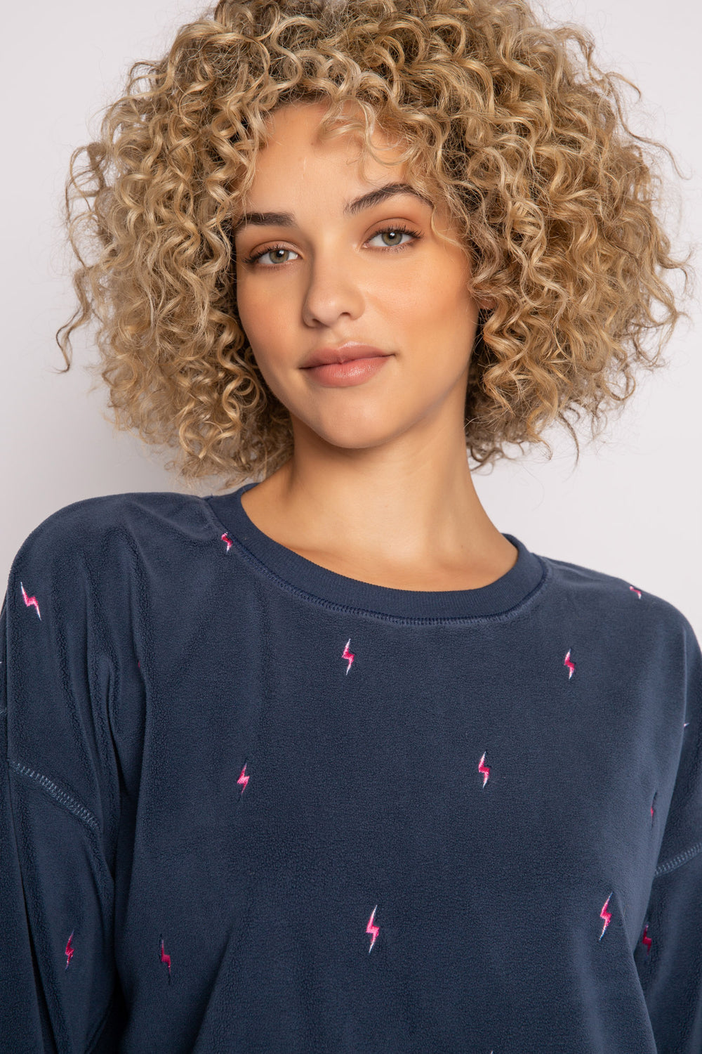 Dark blue pullover top with mini lightning bolt embroideries on exposed boucle' fleece knit. (7231883837540)