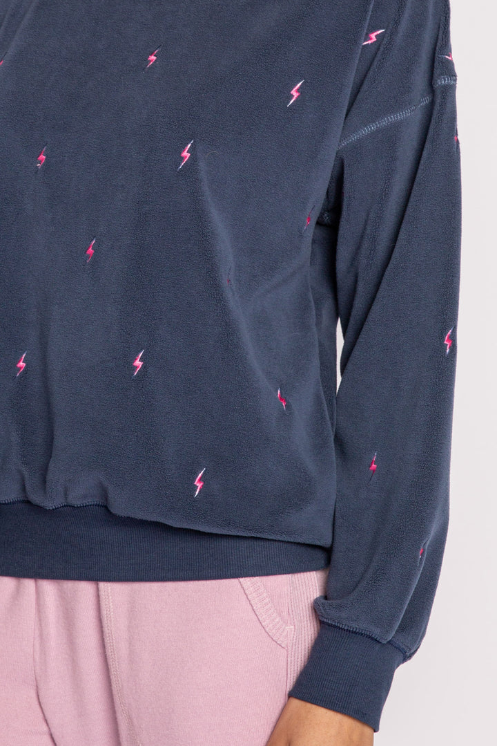 Dark blue pullover top with mini lightning bolt embroideries on exposed boucle' fleece knit. (7231883837540)