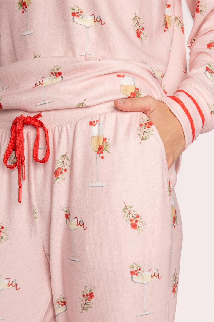 Light pink pj set with mistletoe & cocktail print. Top & straight-leg pant with pockets. Contrast red tie waist. (7257677201508)