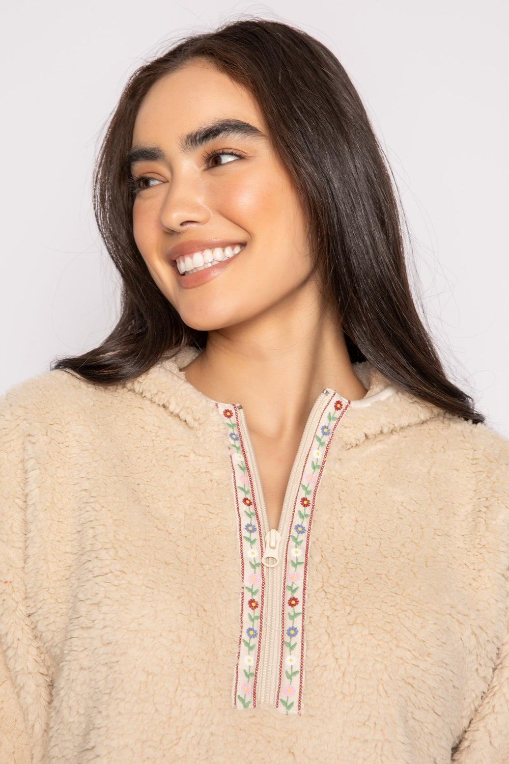 Ivory half-zip pullover in faux shearling fur with embroidered taping. Front pocket & banded cuffs. (7257677299812)