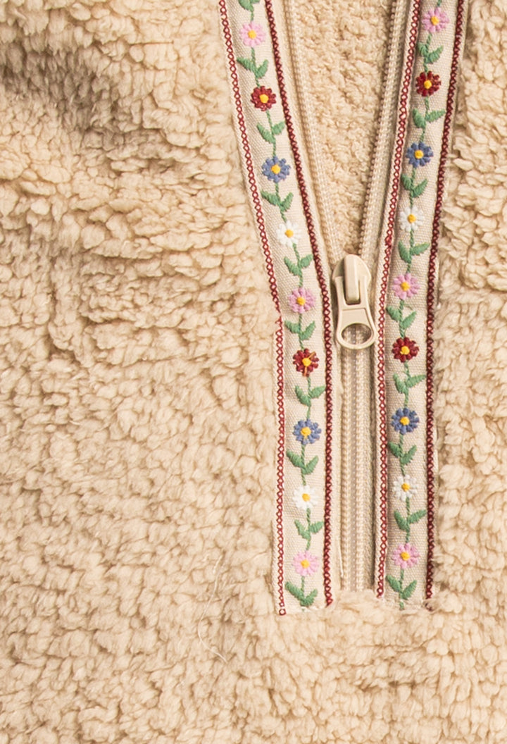 Ivory half-zip pullover in faux shearling fur with embroidered taping. Front pocket & banded cuffs. (7257677299812)