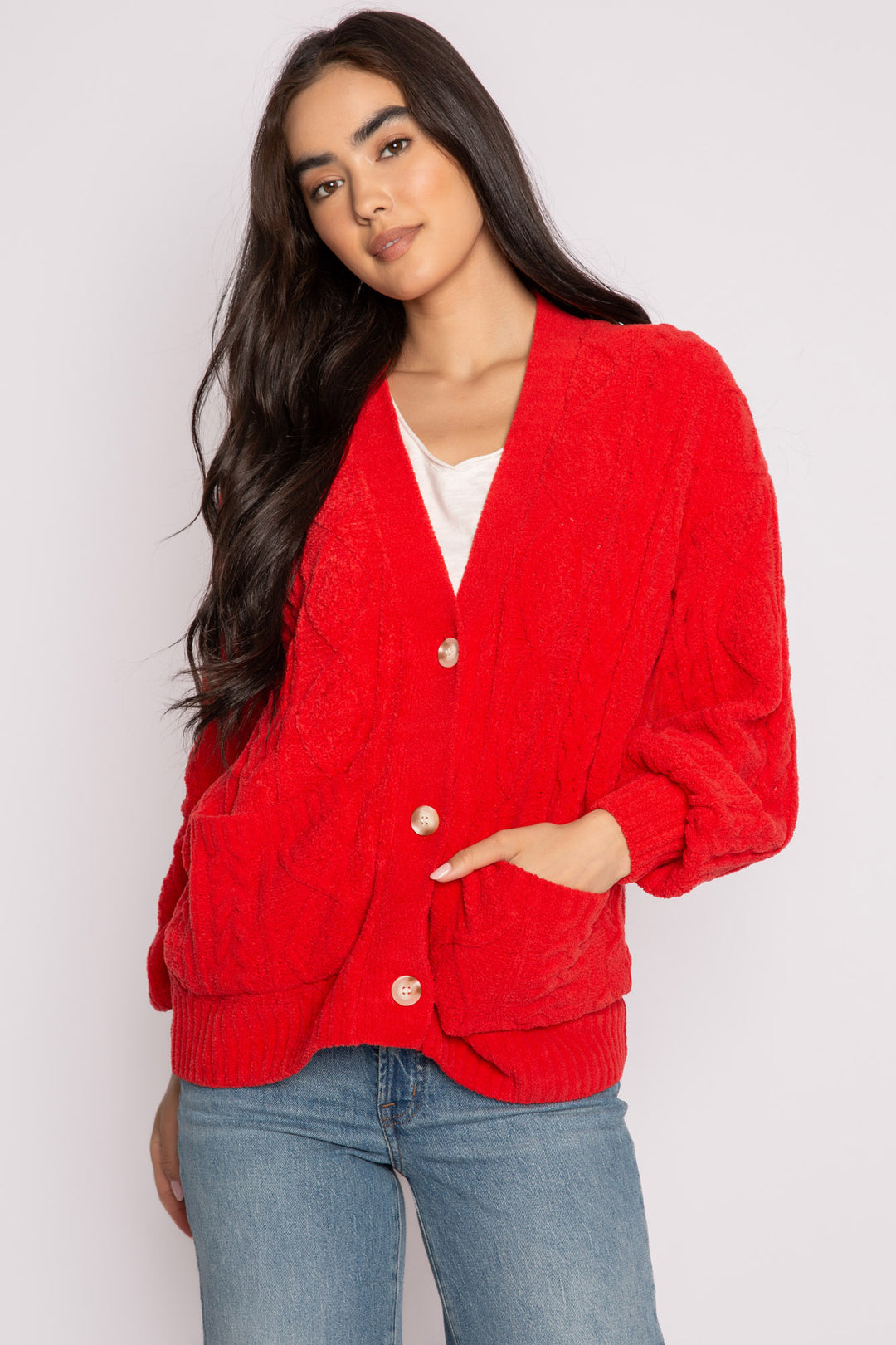 Cardigan sweater in red chenille knit cable pattern. Two lower front pockets & 3-button closure. (7257677987940)