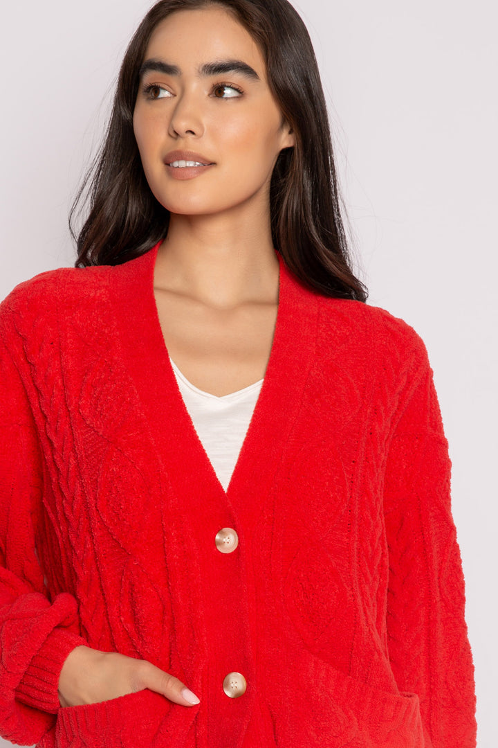 Cardigan sweater in red chenille knit cable pattern. Two lower front pockets & 3-button closure. (7257677987940)