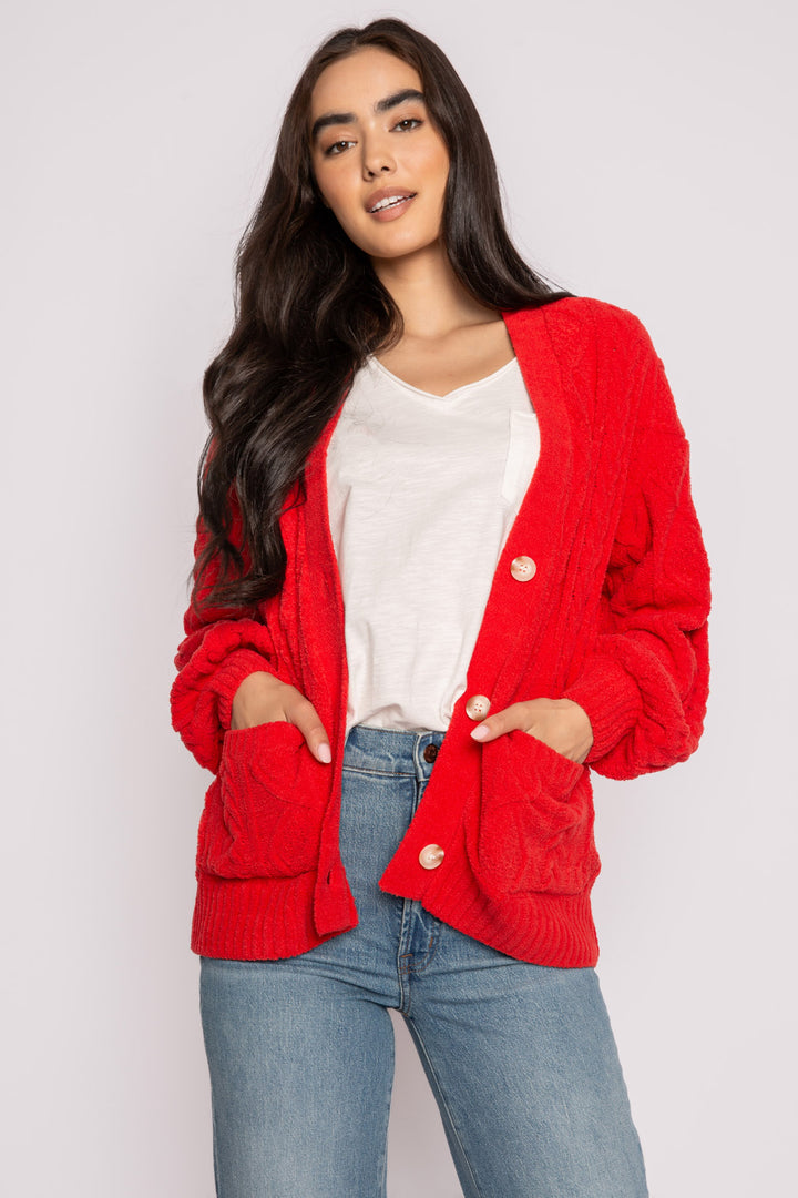 Cardigan sweater in red chenille knit cable pattern. Two lower front pockets & 3-button closure. (7257677987940)