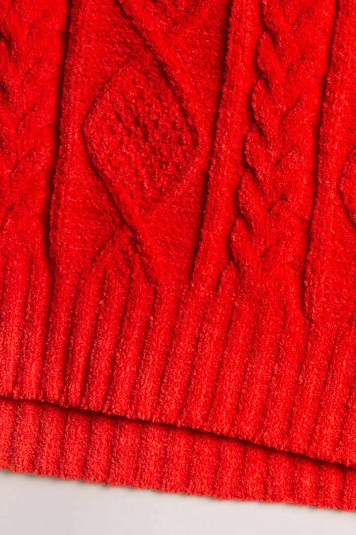 Cardigan sweater in red chenille knit cable pattern. Two lower front pockets & 3-button closure. (7257677987940)