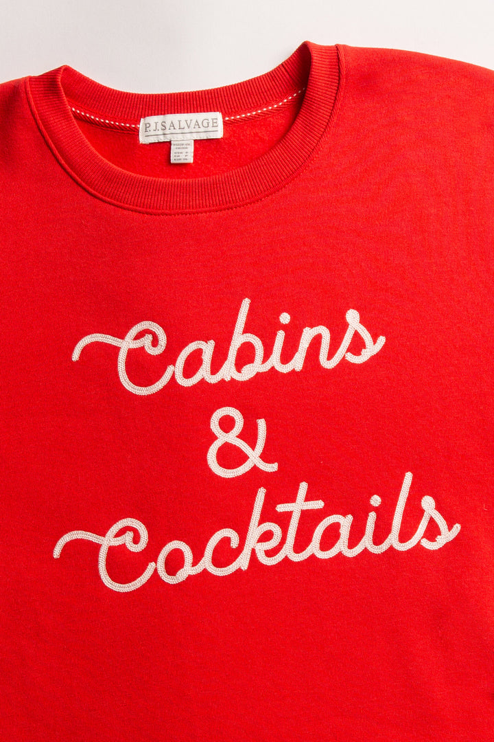 Red fleece pullover top with 'Cabins & Cocktails' script embroidery at chest in ivory. (7257678446692)