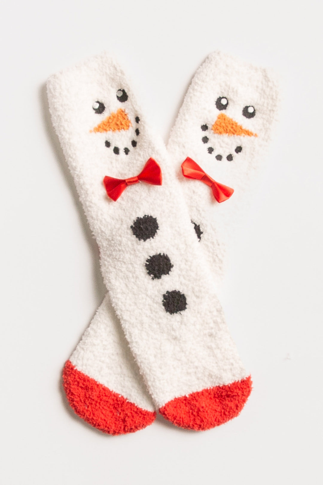 Ivory plush sock with knit snowman-face eyes, nose, bow-tie details. Gripper print on soles for non-skid. (7257678938212)