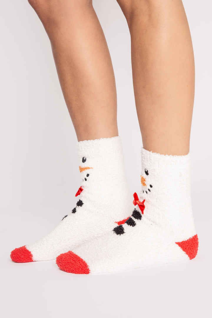 Ivory plush sock with knit snowman-face eyes, nose, bow-tie details. Gripper print on soles for non-skid. (7257678938212)
