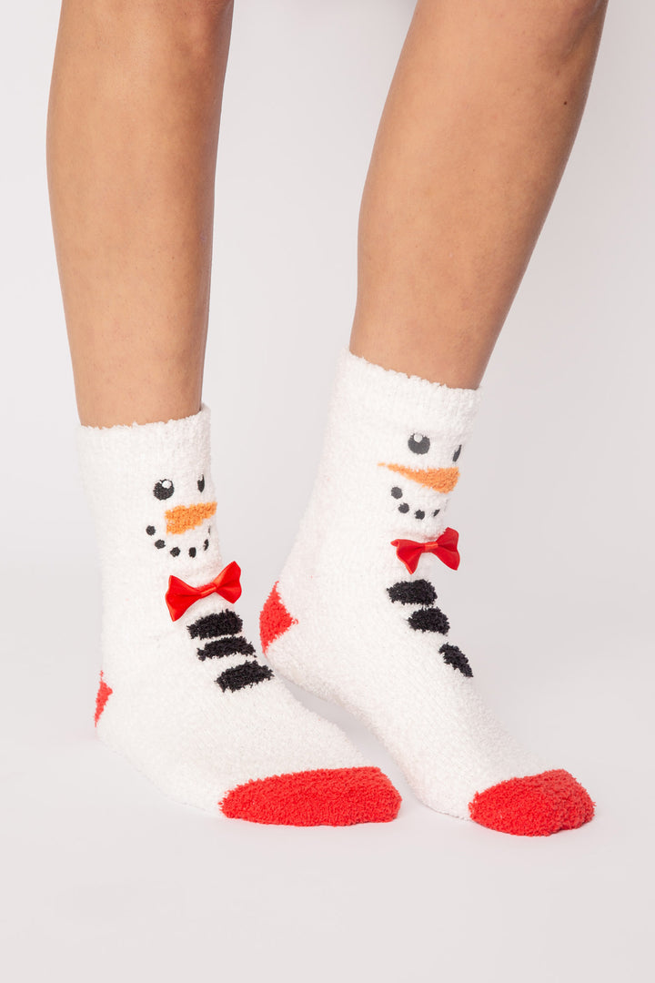 Ivory plush sock with knit snowman-face eyes, nose, bow-tie details. Gripper print on soles for non-skid. (7257678938212)