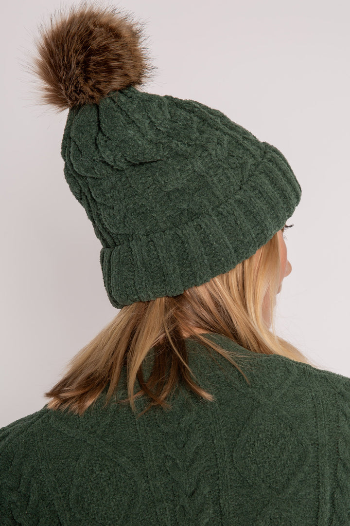 Beanie hat in dark green chenille knit with cable pattern. Tan pom-pom puff at top. (7257679265892)