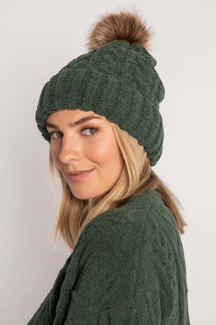 Beanie hat in dark green chenille knit with cable pattern. Tan pom-pom puff at top. (7257679265892)