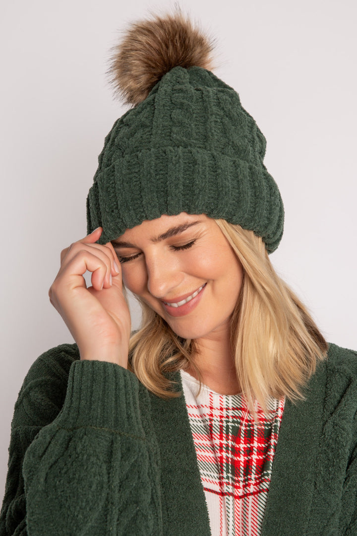Beanie hat in dark green chenille knit with cable pattern. Tan pom-pom puff at top. (7257679265892)