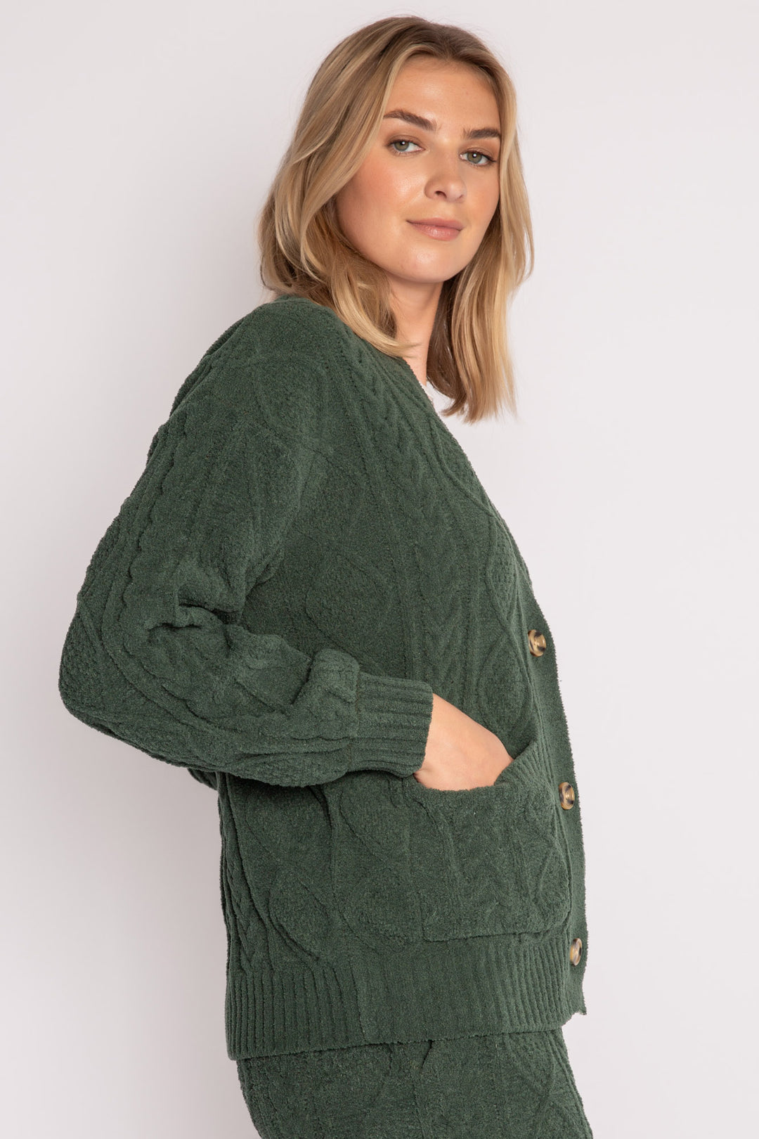 Cardigan sweater in green chenille knit cable pattern. Two lower front pockets & 3-button closure. (7257679298660)