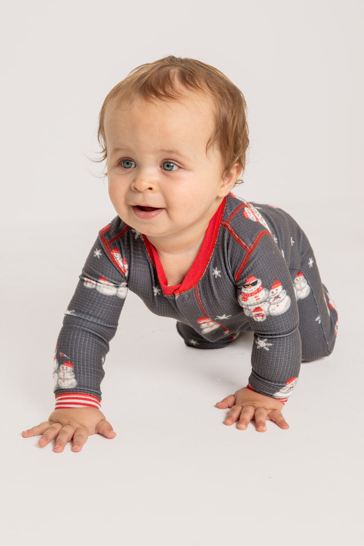 Infant pajama in grey thermal velour with festive snowman print. Red & white striped cuffs. (7257679626340)