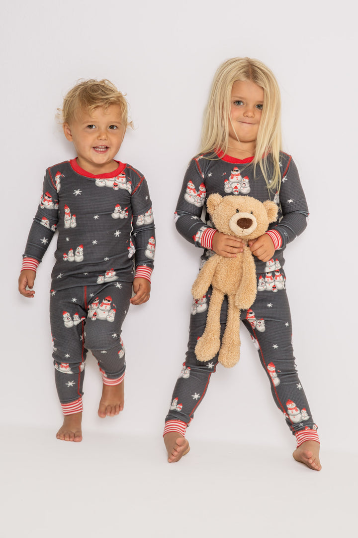 Kids' gender-neutral pj set in grey thermal velour with snowman print. Red & white striped cuffs. (7257679659108)