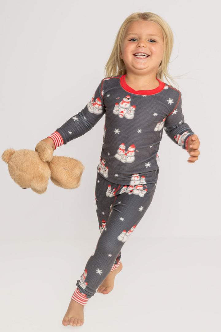 Kids' gender-neutral pj set in grey thermal velour with snowman print. Red & white striped cuffs. (7257679659108)