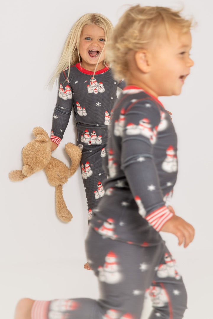 Kids' gender-neutral pj set in grey thermal velour with snowman print. Red & white striped cuffs. (7257679659108)