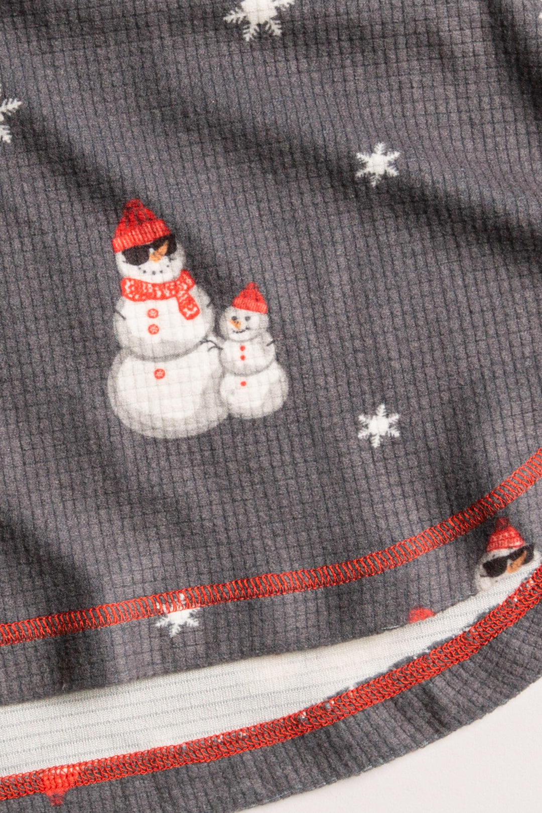 Kids' gender-neutral pj set in grey thermal velour with snowman print. Red & white striped cuffs. (7257679659108)