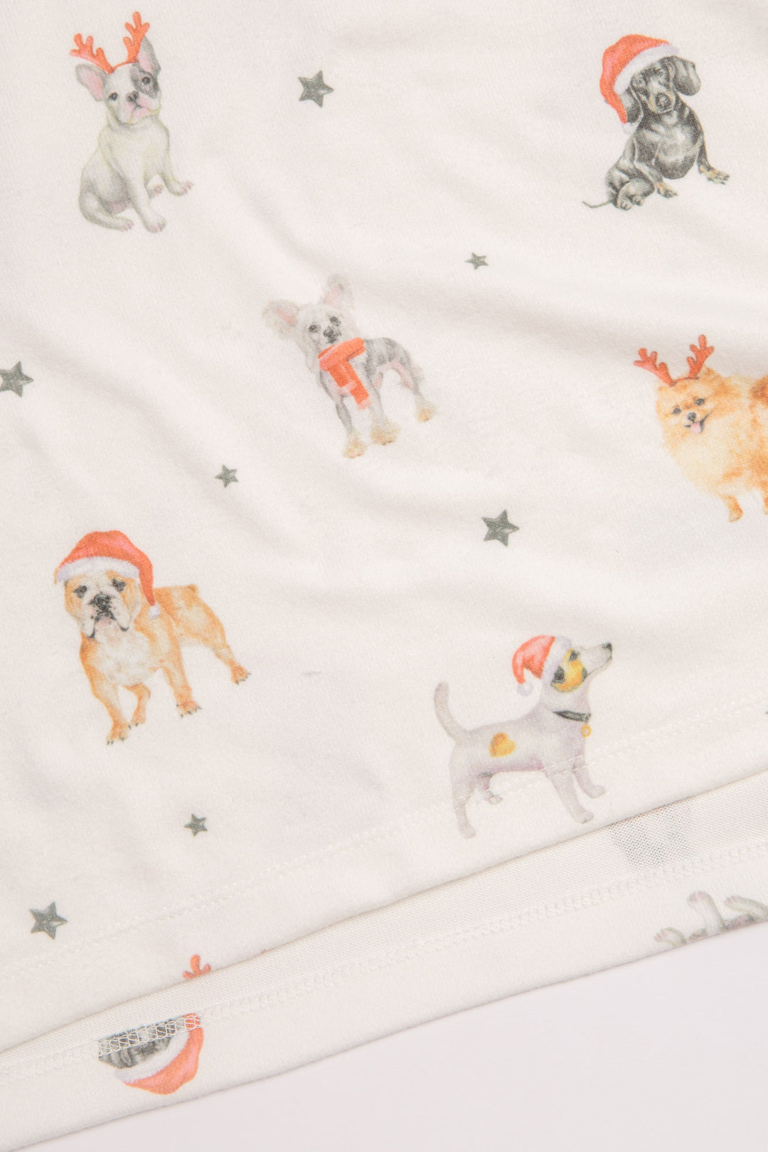 Festive dog-printed pajama set in butter jersey. Red piping collar & side of pant. Red waist ties. (7257680805988)