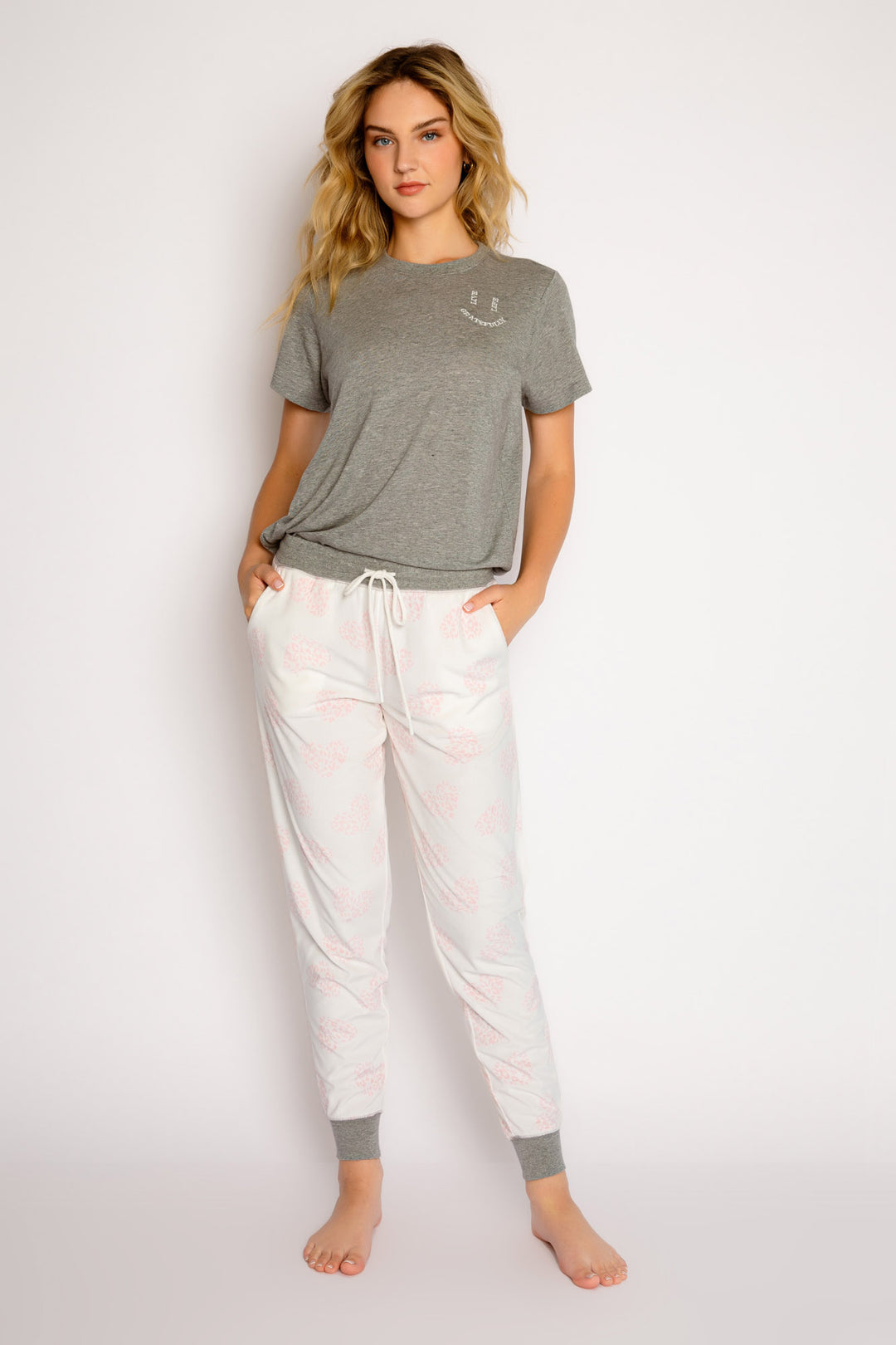 Ivory jammie pant with pink leopard-heart print. Contrast grey cuff & waistband. Pant has side pockets. (7325666639972)