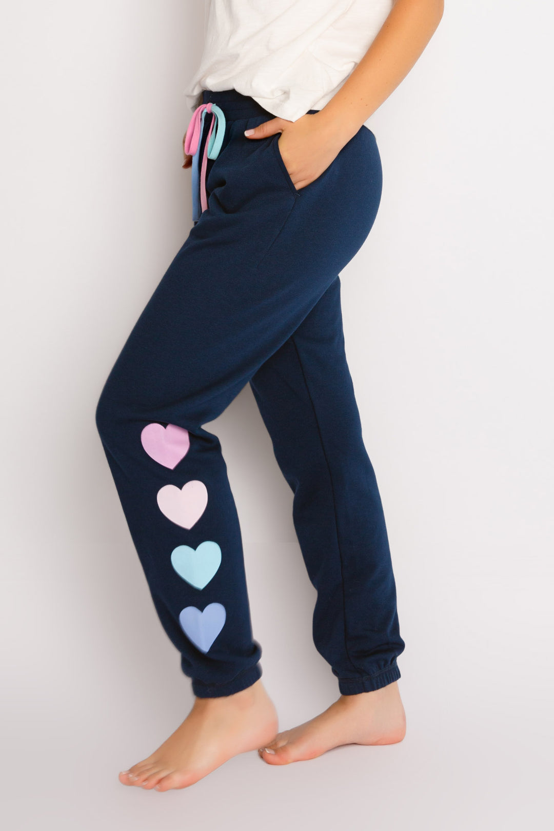 Navy high-pile fleece jogger pant with multi heart graphic printed on left leg. Ombre' colored waist ties. (7325667557476)