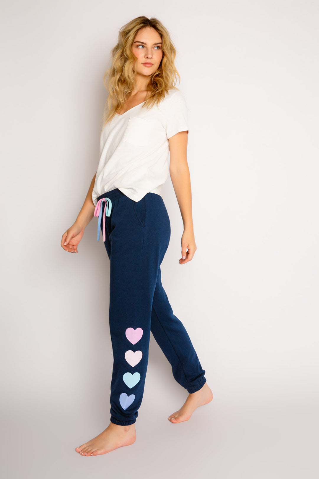 Navy high-pile fleece jogger pant with multi heart graphic printed on left leg. Ombre' colored waist ties. (7325667557476)