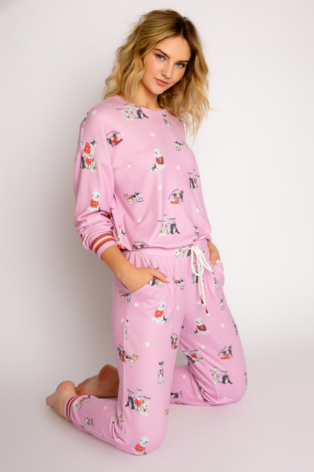 Pink pajama set in peachy knit with rescue-dog theme print. Long sleeve top & jammie pant. (7325668638820)