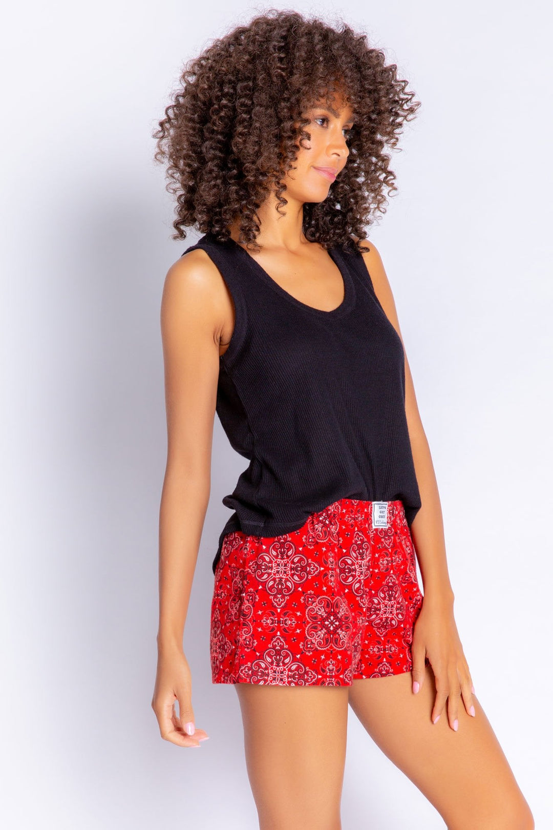 Red flannel shorts in bandana/paisley style print. Elastic waist and faux snap fly. (6576915677284) (7000967905380)