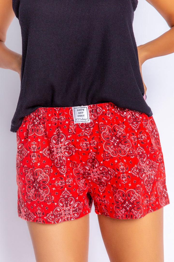 Red flannel shorts in bandana/paisley style print. Elastic waist and faux snap fly. (6576915677284) (7000967905380)