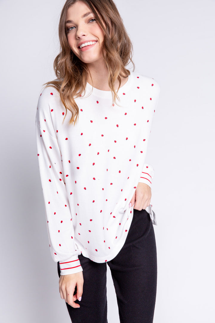 Soft ivory lounge top with lady bug print and striped red cuffs. Relaxed fit. (6639335997540)